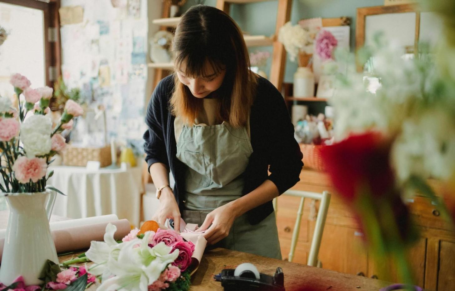 Professional flower arrangement being prepared with attention to detail